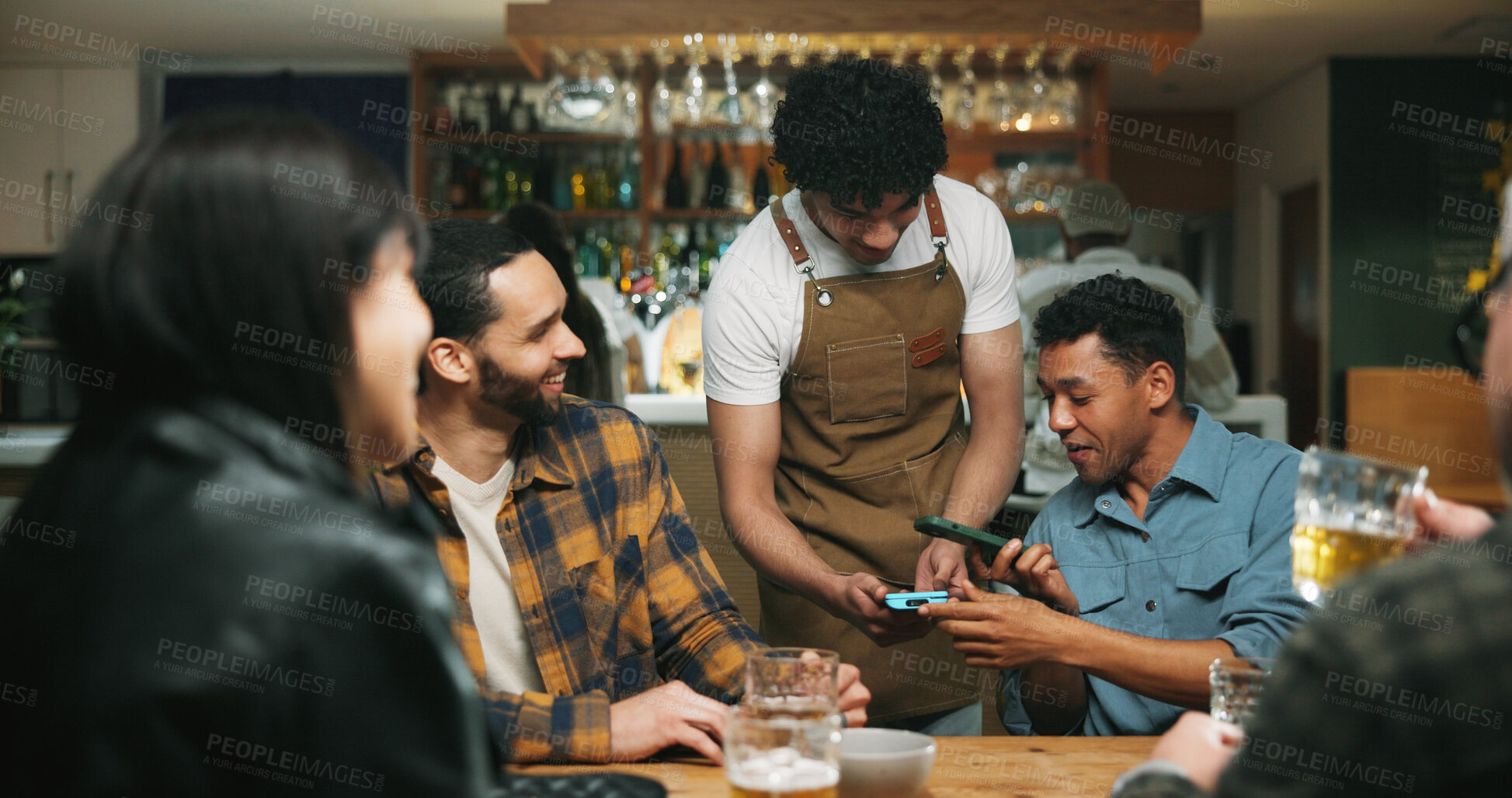 Buy stock photo Waiter, man and phone with payment at pub for beer purchase, paperless transaction or drinking. Friends, people or server with POS machine in bar for easy banking, drinks checkout or social gathering