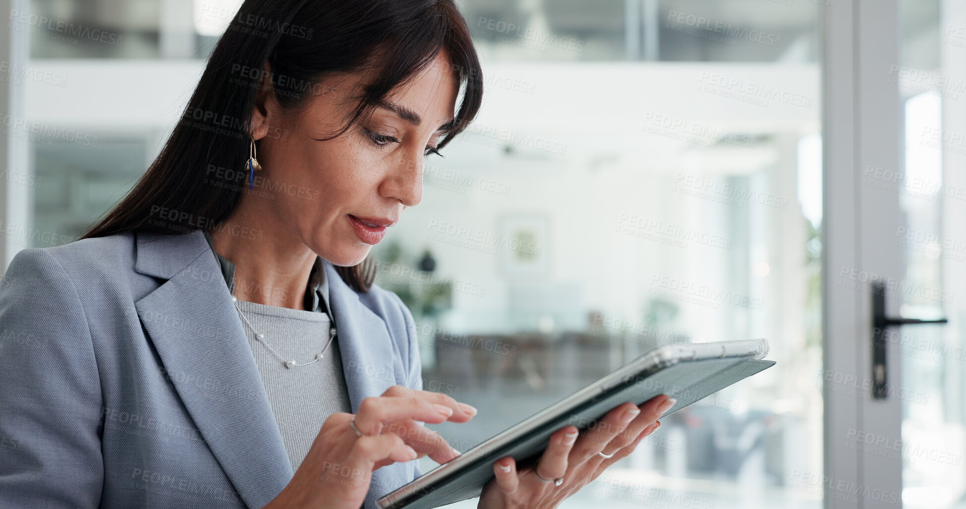 Buy stock photo Reading, mature or business woman with tablet in office, planning or check report for fund management. Review portfolio performance, scroll or wealth manager monitor assets, track market or tech
