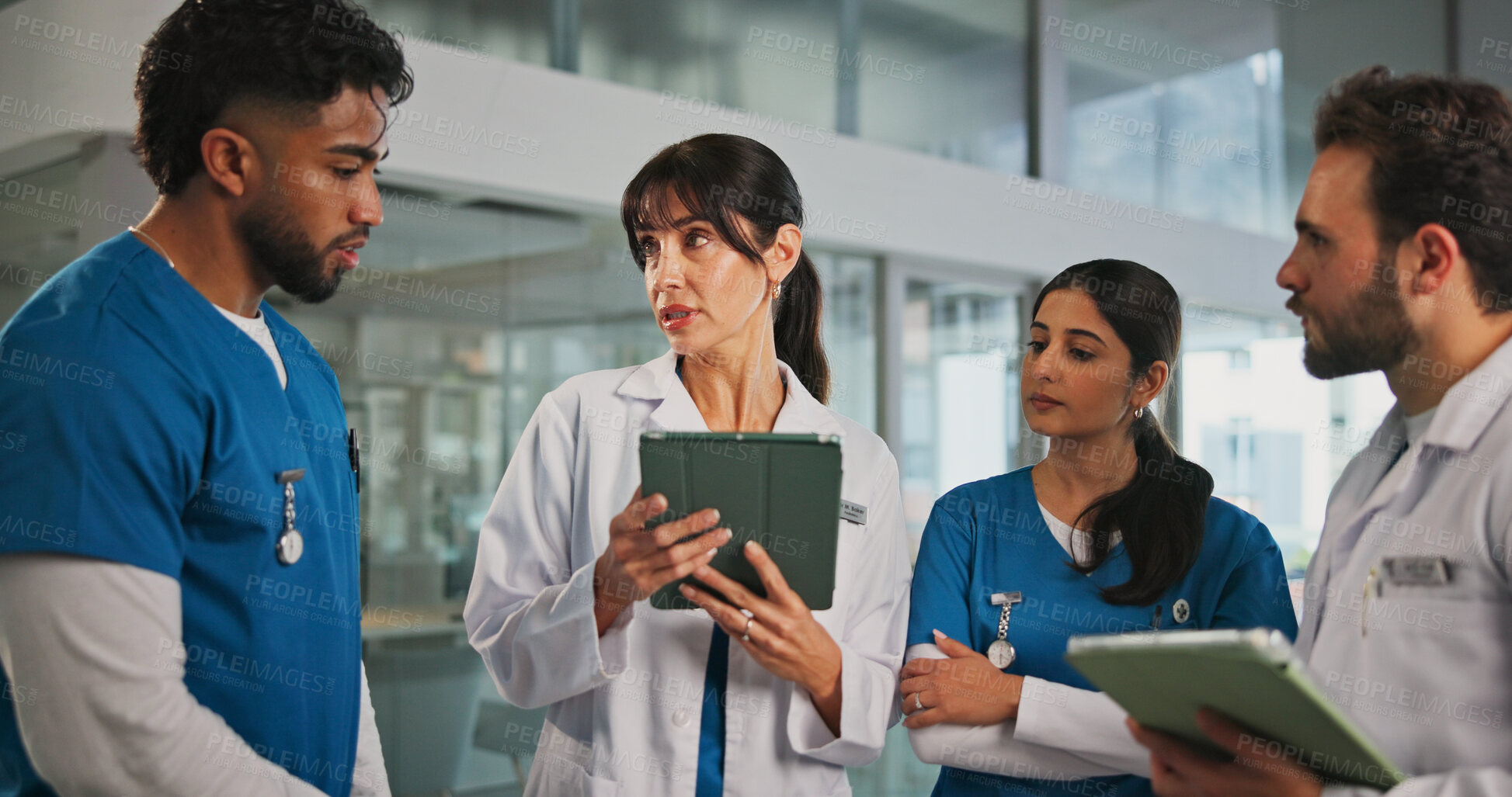 Buy stock photo Tablet, talking and doctors with nurses in hospital for medical report, research or feedback. Digital technology, collaboration and team of healthcare employees in discussion for advice in clinic.