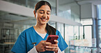 Phone, woman and nurse in hospital with typing for texting, communication or email for telehealth. Happy, technology and healthcare worker with cellphone for contact, networking or medical support.
