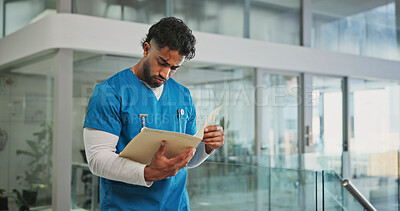 Buy stock photo Doctor, folder and review in lobby at hospital with medical report, serious or feedback for diagnosis. Person, healthcare professional and document for insight, info or solution at wellness clinic