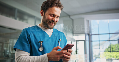 Buy stock photo Phone, man and nurse in hospital with typing for texting, communication or email for telehealth. Happy, technology and male healthcare worker with cellphone for contact, networking or medical support