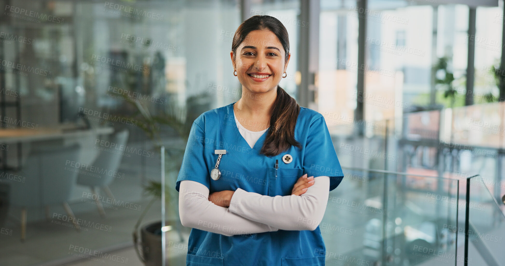 Buy stock photo Woman, nurse and smile at clinic with arms crossed, confidence and pride in corridor for healthcare. Person, medical professional and happy for service, portrait and wellness at hospital in Colombia