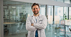 Portrait, smile and doctor with arms crossed in hospital for career pride, about us and medical service. Happy, man or job ambition for healthcare assistance, patient care and confidence for wellness