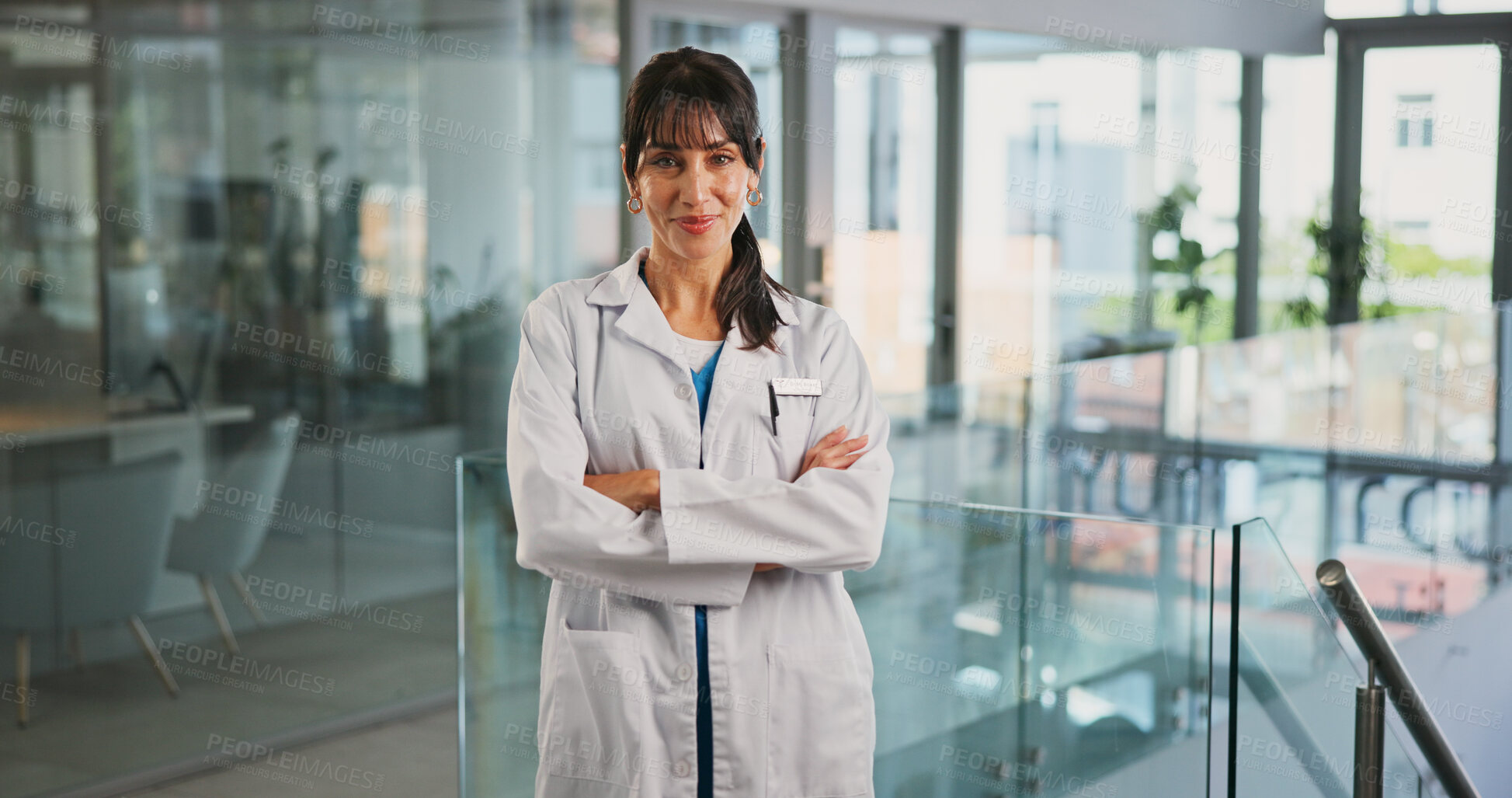 Buy stock photo Portrait, smile and doctor with arms crossed in hospital for career pride, about us and medical service. Happy, woman and ambition for healthcare assistance, patient care and confidence for wellness