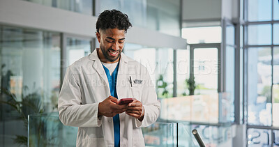 Buy stock photo Phone, man and doctor in hospital with typing for texting, communication or email for telehealth. Happy, technology and healthcare worker with cellphone for contact, networking or medical support.