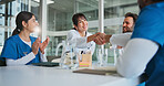 Hospital, applause and doctors with handshake in meeting for promotion, agreement and partnership. Healthcare, medical team and men and women shaking hands to celebrate, collaboration and thank you