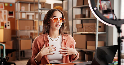 Buy stock photo Sunglasses, live stream and ecommerce with woman in warehouse for startup promotion and chat. Content creation, online shopping ambassador and influencer with person and accessory for broadcast 