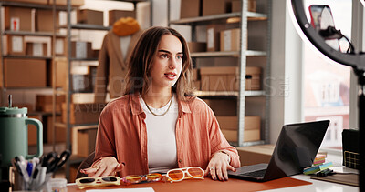 Buy stock photo Sunglasses, influencer and phone with woman in warehouse for startup, promotion and ring light. Content creation, online shopping ambassador and live stream with person and accessory for broadcast 