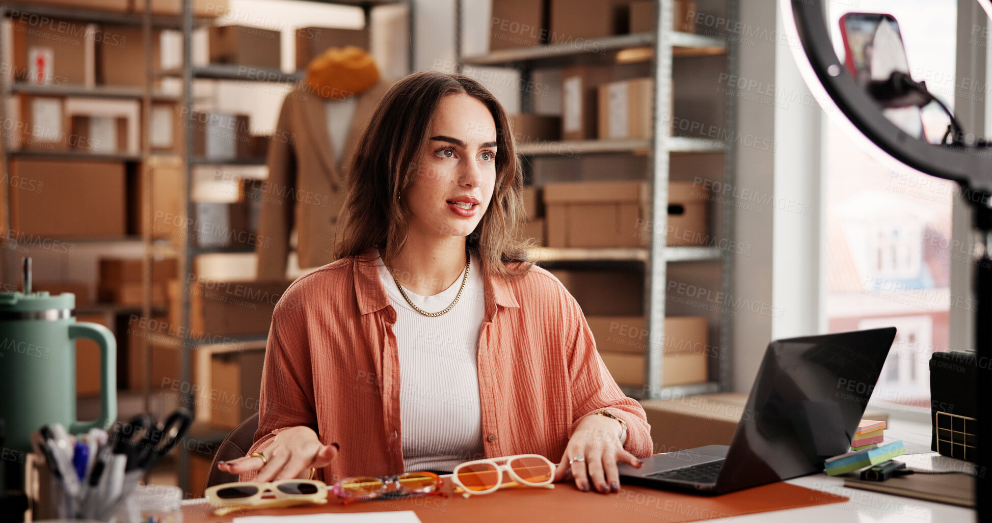 Buy stock photo Sunglasses, influencer and phone with woman in warehouse for startup, promotion and ring light. Content creation, online shopping ambassador and live stream with person and accessory for broadcast 