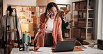 Woman, designer and phone call with laptop at workshop, smile or dropshipping order at startup. Person, smartphone and computer for talk, happy and contact with creative project for clothes at studio