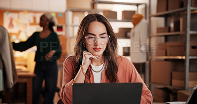 Buy stock photo Woman, laptop and review for dropshipping, fashion or notification with inventory management at startup. Person, entrepreneur and designer with computer, feedback or glasses for ecommerce at workshop