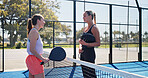 Conversation, fitness and padel with women on court together for practice or training session. Exercise, sports or tennis with coach and player talking outdoor for development or skill or technique