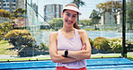 Portrait, tennis and happy woman with arms crossed, fitness and sports game with hobby. Player, padel court and confident person with smile, pride and training with exercise, practice and competition