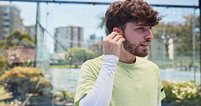 Buy stock photo Earphones, tennis and man with fitness, training and listening to music, sound track and radio. Player, outdoor and healthy person with song, podcast and playlist album with practice, tech and hobby