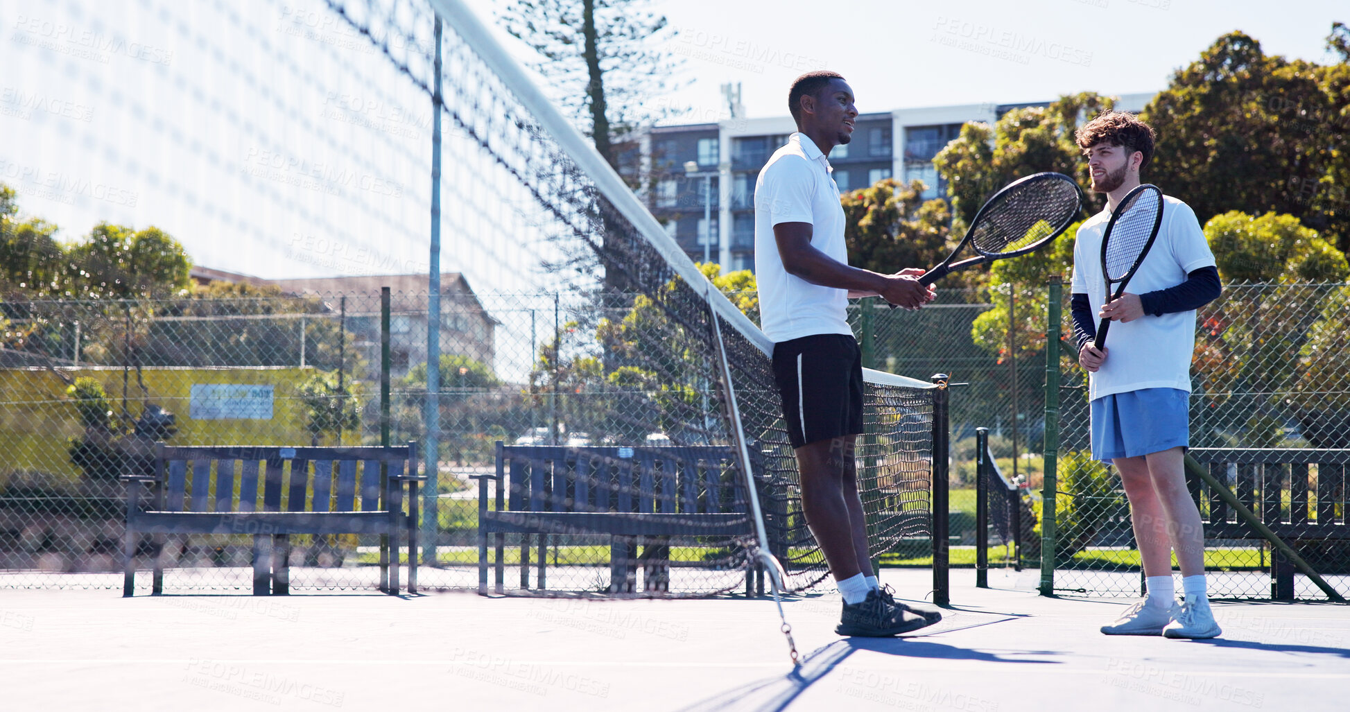 Buy stock photo Tennis court, friends or men with racket for game, sport hobby or conversation for workout break. Equipment, discussion or players rest by net after friendly match, outdoor or exercise from low angle