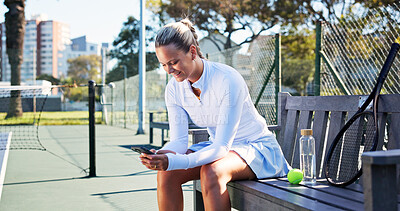 Buy stock photo Smile, woman and relax with phone on tennis court for fitness, training app and match progress. Happy, female person and mobile on bench for sports break, video demonstration and online tips for game
