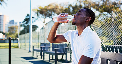 Buy stock photo Tennis court, fitness and black man drinking water from bottle, complete training and sports workout. Summer practice, cardio exercise and thirsty athlete with liquid for hydration, outdoor and break