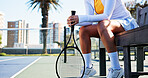 Woman, hands and tennis racket on court bench for competition strategy, tactical idea and recovery. Sports gear, athlete legs and person on turf with break for game plan, tournament and contest rest.