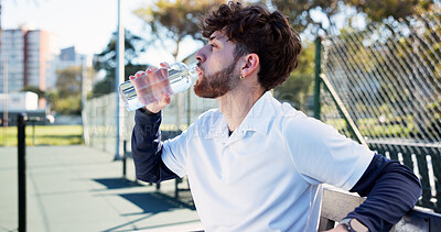 Buy stock photo Tennis court, fitness and man drinking water from bottle, complete training and sports workout. Summer practice, cardio exercise and thirsty athlete with liquid for hydration, outdoor match and break