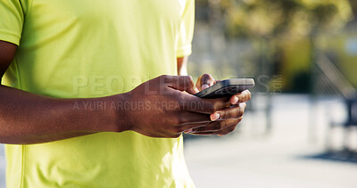Buy stock photo Fitness, phone and hands on court with typing, message update or exercise post on social media. Digital, man or athlete outdoor with mobile, wellness chat or virtual tutorial on training break