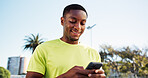 Fitness, phone and black man outdoor with smile, message update or exercise post on social media. Digital, reading or athlete in park with mobile, wellness chat or virtual tutorial on training break