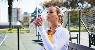 Buy stock photo Tennis court, fitness and woman drinking water from bottle, complete training and sports workout. Summer practice, cardio exercise and thirsty athlete with liquid for hydration, outdoor rest or break