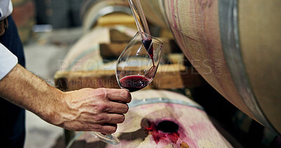 Buy stock photo Hands, person and red wine with barrel in cellar for taste testing, quality control and production. Sommelier, glass and alcohol extraction for sampling, evaluation process and beverage inspection