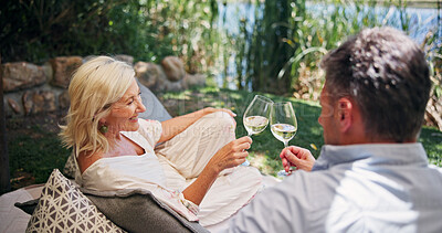Buy stock photo Mature couple, toast and wine outdoor at resort with conversation for bonding, connection and together. Cheers, man and woman in nature with alcohol, romantic getaway and sightseeing with date