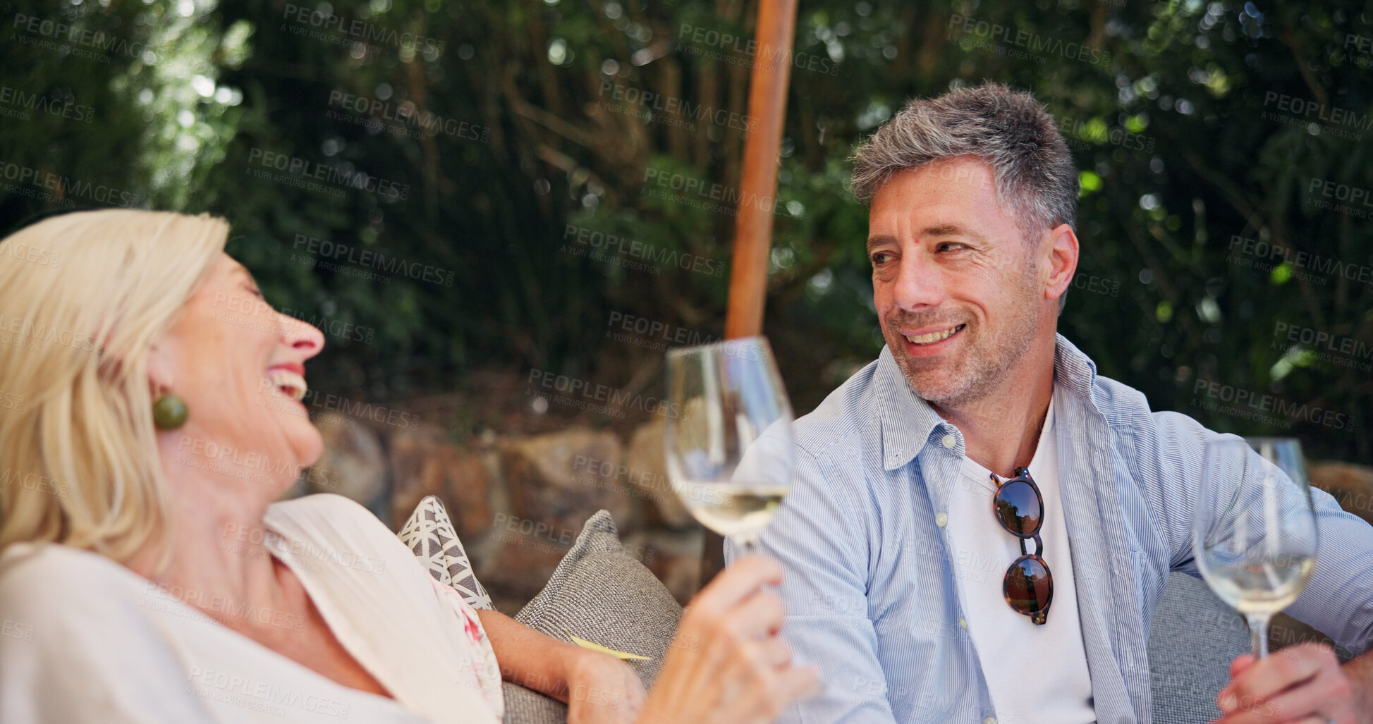 Buy stock photo Relationship, laugh or couple at lodge with wine, happiness or bonding in anniversary celebration. Honeymoon, love or mature people at resort with drink, commitment or connection in romantic date