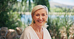 Portrait, mature woman and smile outdoor for travel, summer tourism and holiday adventure. Happy, female person and relax at luxury retreat, explore nature and getaway trip for vacation destination