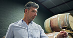 Mature man, glass and red wine in cellar for inspection, quality control and production. Male person, alcohol and sensory ritual for aroma, balance flavour and evaluation process to prepare palate