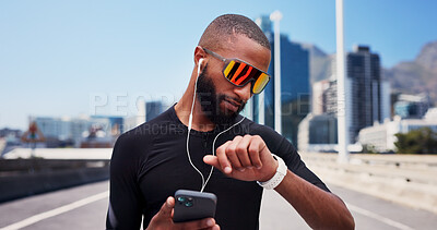 Buy stock photo Man, runner and phone with smart watch in city, sunglasses and iot with fitness, streaming or audio. Person, stopwatch and smartphone with mobile app, timer or listen to music on bridge in urban town