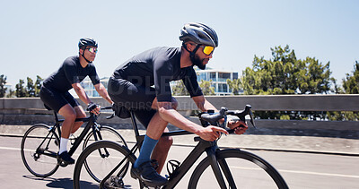 Buy stock photo Fitness, men and cycling on bike in city for triathlon challenge, competition workout or sport. Active, people and bicycle on bridge for cardio exercise, marathon endurance and pace training for race