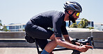 Fitness, cycling and man on bicycle in city for competition exercise, endurance challenge or wellness. Cyclist, profile and black person on bike for triathlon practice, sports performance or training