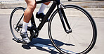 Cycling, legs and athlete on bicycle, city or practice competition on urban road, journey and active. Outdoor, cyclist and person on bike for sport tournament, training and eco friendly transport