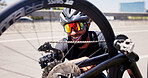 Sports, repair and man with bicycle in street to check wheel, tire and gears for maintenance outdoor. Happy, fitness and person fixing bike in city for cycling, training and active hobby for exercise