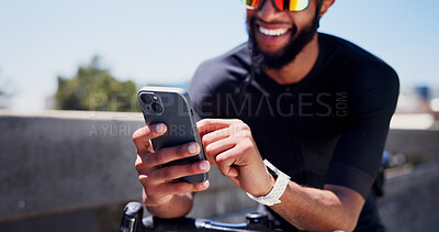 Buy stock photo Hands, bicycle and phone for fitness in city, contact and smart watch with texting, break or tracking. Black man, bike and smartphone with mobile app, monitor and sky with exercise on bridge in town