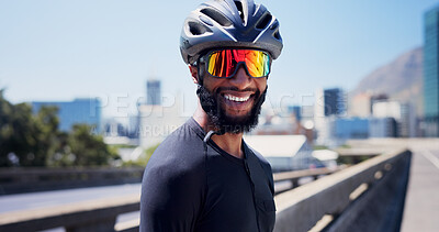 Buy stock photo Black man, cyclist and smile with sunglasses in city, fitness and helmet on bridge, break or pride in street. African person, confident and rest for training, exercise or happy on road in urban town