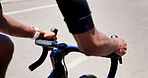 Cycling, hands and athlete on bicycle, outdoor and practice competition on road, active and journey. City, cyclist and person on bike for sport tournament, travel and eco friendly transport on street