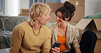 Boxes, conversation and moving day with couple in apartment together for property investment. App, real estate and smile with happy people on floor in living room of new home for house relocation
