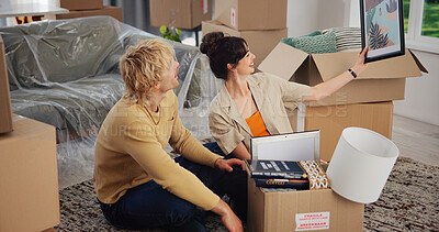 Buy stock photo Happy couple, art and new home with boxes for renovation, moving in or interior decor together. Man, woman or homeowners with picture frame or unboxing for mortgage or property investment in house