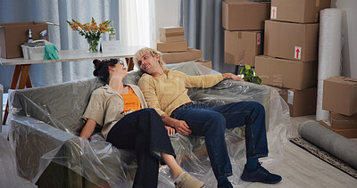 Buy stock photo Rest, moving and couple on sofa in new home for relocation to house, property and rental apartment. Marriage, relax and tired man and woman on couch happy for purchase, mortgage and real estate