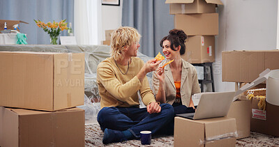 Buy stock photo Laptop, pizza and smile with couple in new home together for fresh start or property relocation. Boxes, computer and food with happy people eating takeaway on moving day for real estate investment