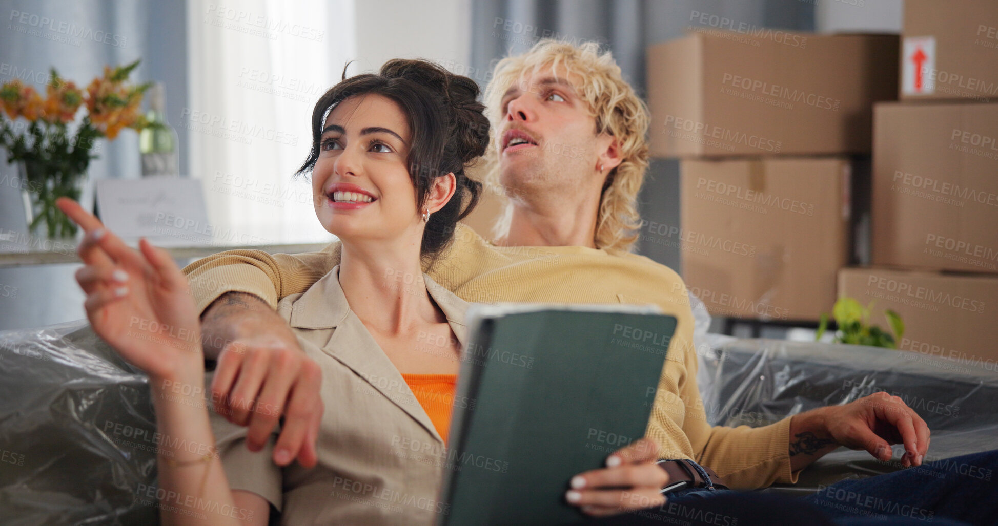 Buy stock photo Couple, tablet and planning with boxes in new home for bonding, interior design and idea app in property. People, technology and relocation in lounge for love, real estate development or renovation