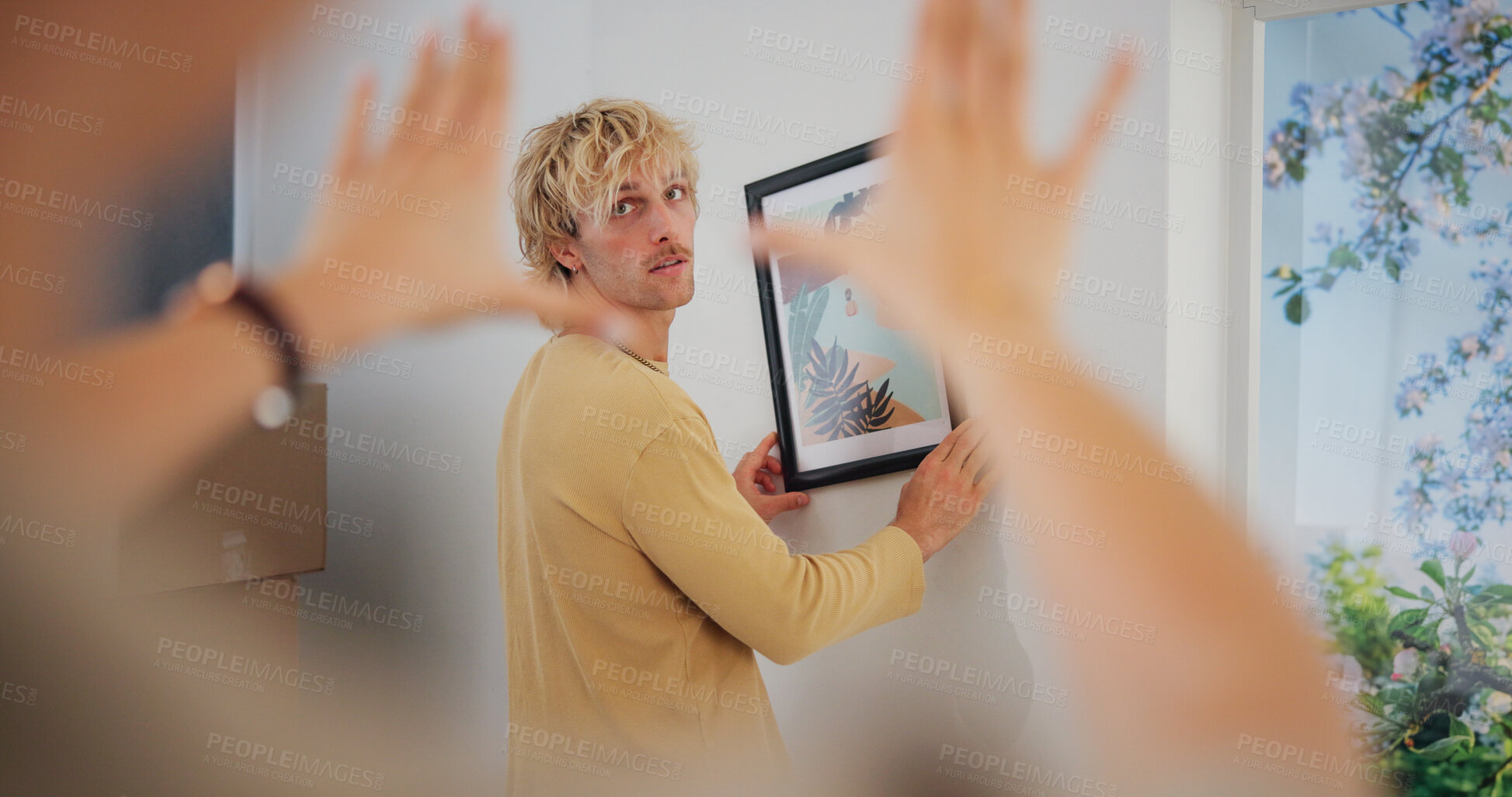 Buy stock photo Hanging picture, measure and moving day with couple in new home together for interior design. Adjust, boxes and frame with people in apartment for property or real estate investment with teamwork