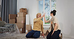 Couple, high five and moving in with boxes in new home for bonding, connection and celebration in property. People, teamwork and relocation in living room for love, real estate and investment