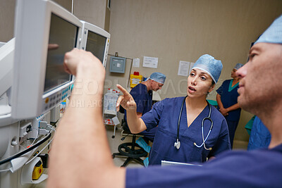 Buy stock photo Surgeon, team and discussion with monitor in emergency room at hospital, review and results. Doctors, medical staff and point with advice, feedback or solution for people in theater at clinic