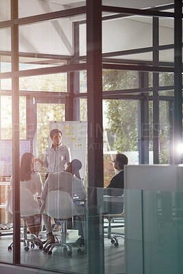 Buy stock photo Presentation, discussion and businesswoman with team in glass office with statistics for finance report. Whiteboard, meeting and financial advisors with charts, data or graphs for investment plan.