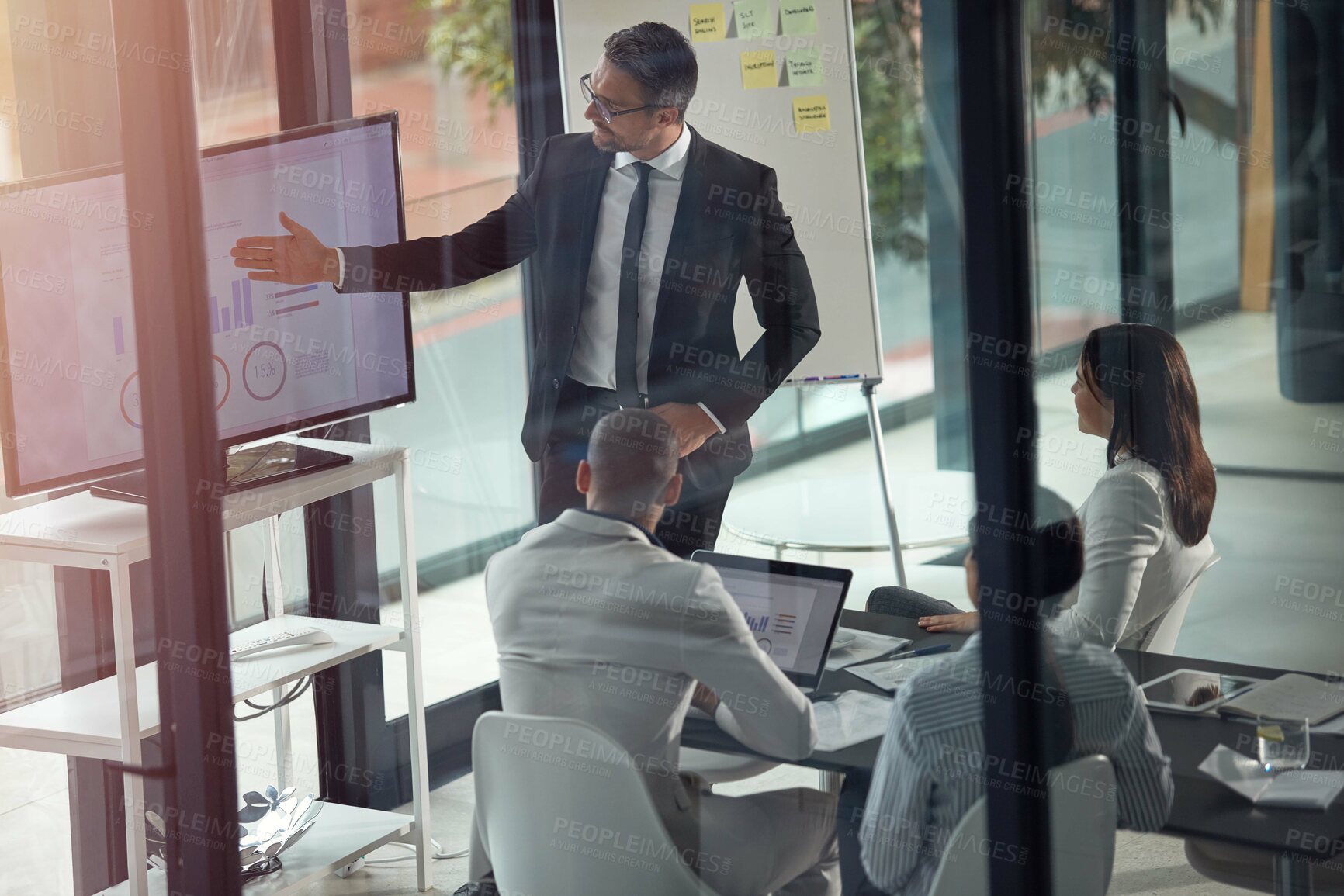 Buy stock photo Presentation, screen and businessman with team in glass office with statistics for finance report. Whiteboard, meeting and group of financial advisors with charts, data or graphs for investment plan.